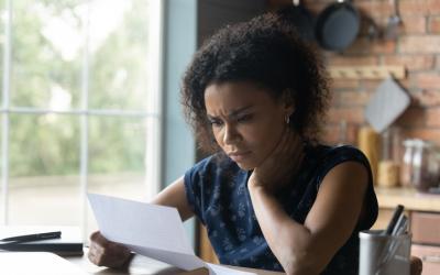 woman reading letter with frustrated or confused face