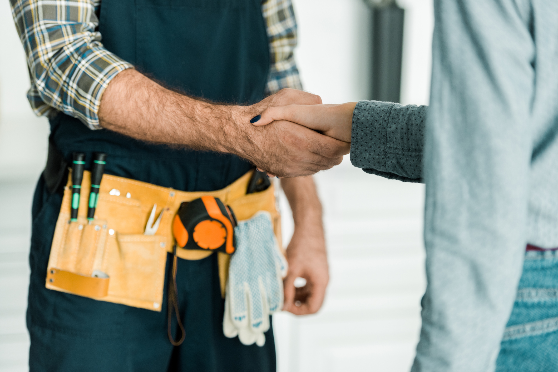 maintenance man shaking hands with a woman