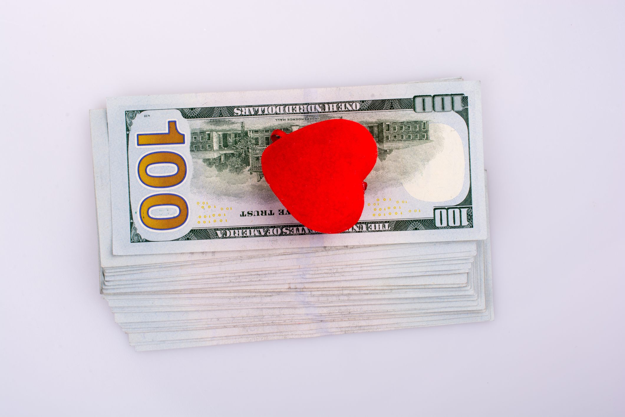 100 dollar bills with heart on top