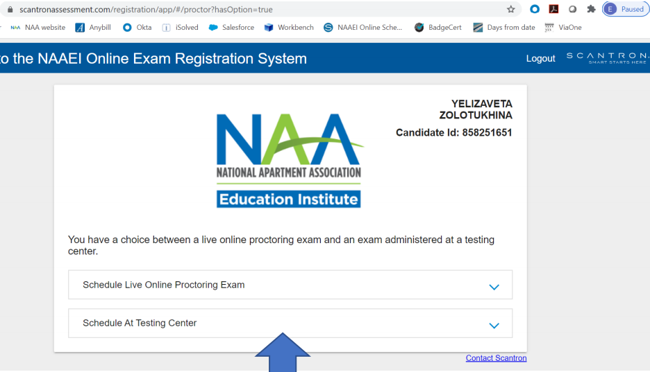 A page for the user to choose which location they would like to take their test. A blue arrow points to the option, "Schedule at Testing Center".