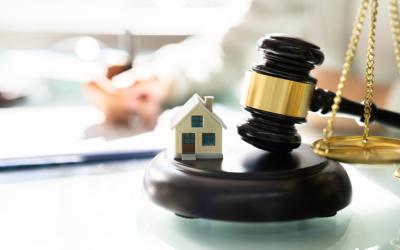 Photo of a gavel, the scales of justice and a house.