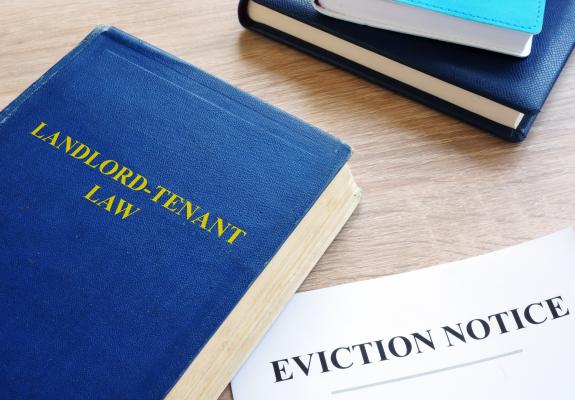 book of landlord tenant law next to eviction notice