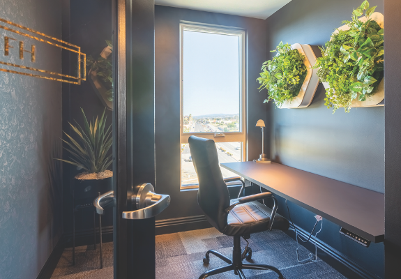 small office room with plants on the wall
