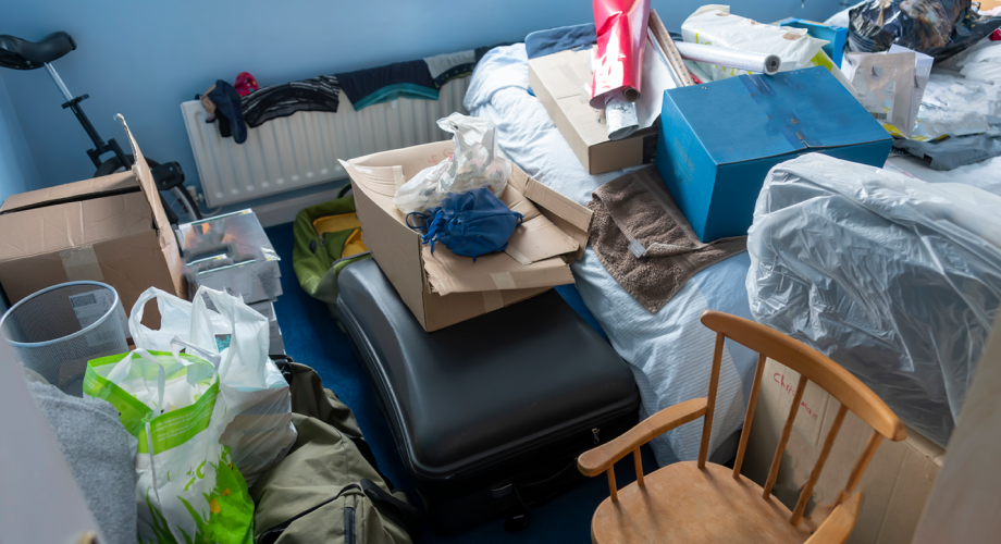 bedroom with lots of clutter and garbage in it