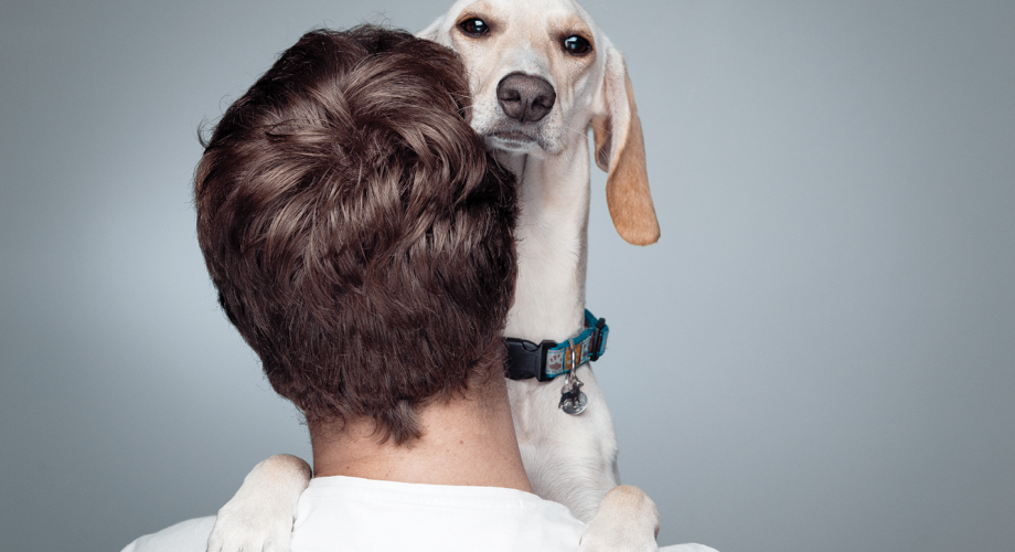 man with a dog on his shoulder