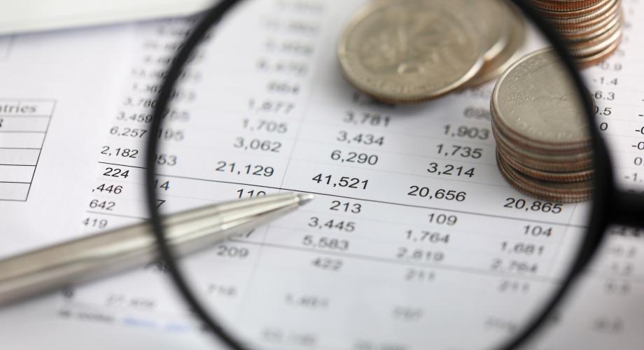 magnifying glass over balance sheet