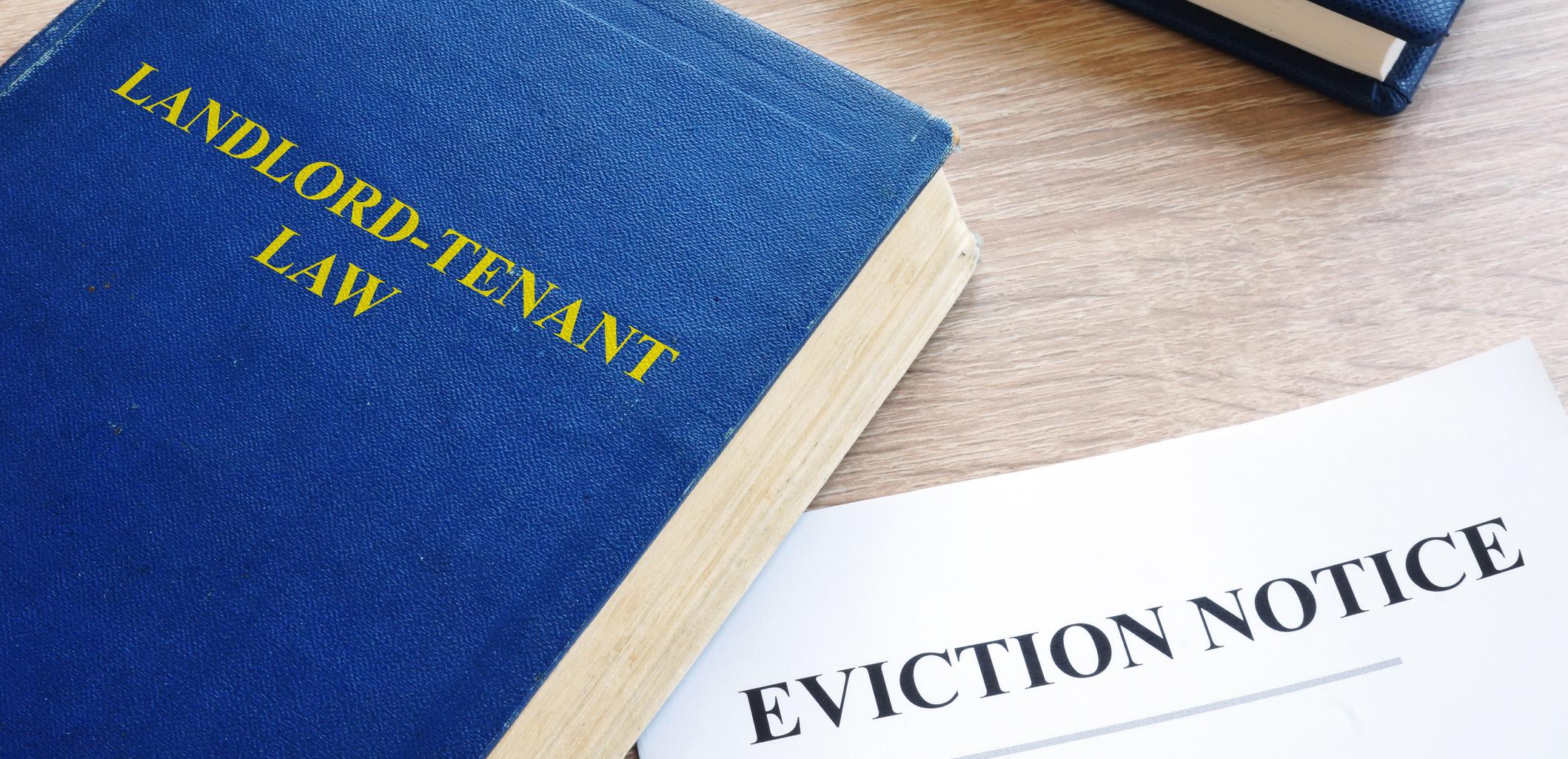 book of landlord tenant law next to eviction notice